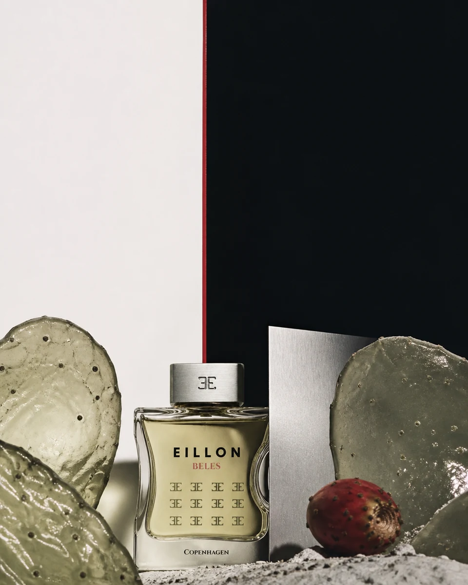 Beles among translucent nopal forms, brushed aluminium, red fruit, and split bone-and-ink fields.