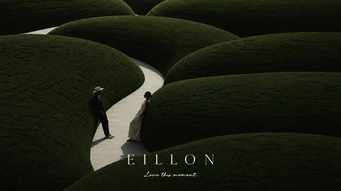 Two figures on a pale winding path through vast, sculpted green forms