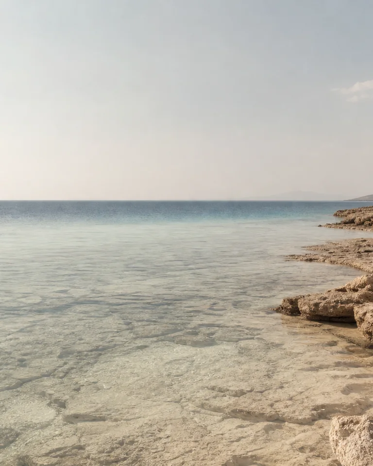 Blue water, pale stone and salt haze in a conceptual coastal material study.